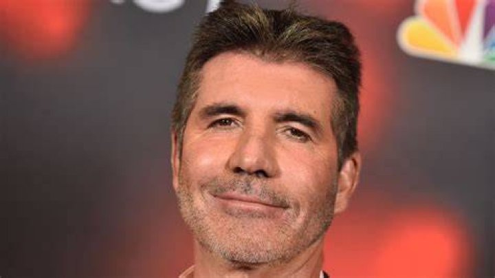 Simon Cowell, 61, is seen with a medical breathing apparatus (next to a packet of cigarettes) as he heads home with partner Lauren Silverman, 43, after a dinner date in London. Photo / Getty