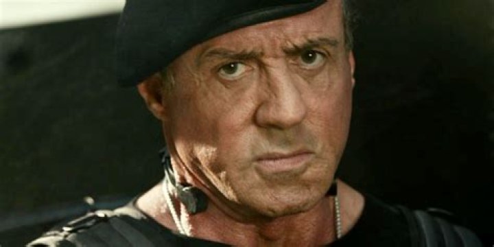 Sylvester Stallone as Barney Ross Pointing a Gun in The Expendables 2