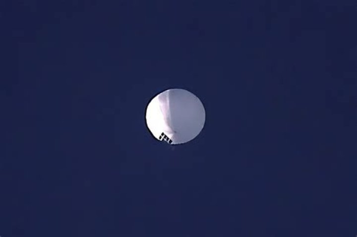 The balloon drifts above Kingstown, North Carolina, with an airplane and its contrail seen below it. Photo / Brian Branch, via AP
