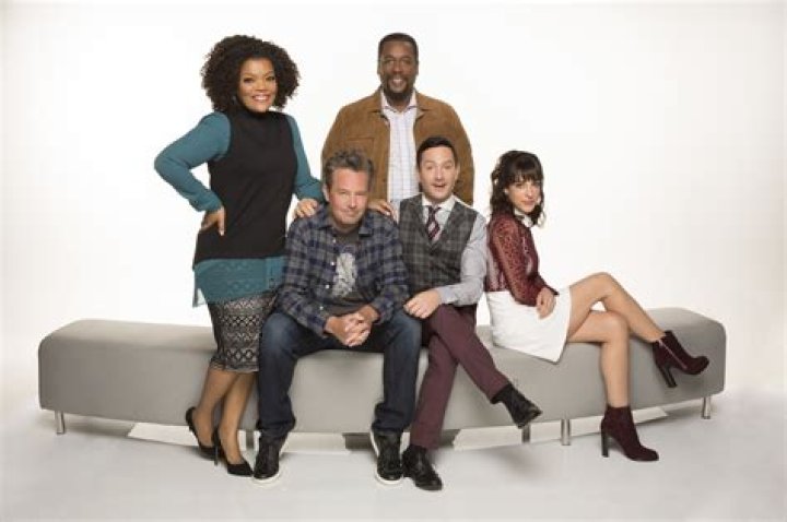 The cast of The Odd Family standing on a road