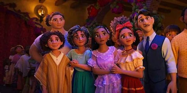 The Madrigal family gathers to look at something in Disney's Encanto.