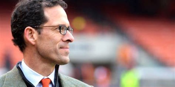 The real Paul Depodesta from Moneyball standing on a baseball field