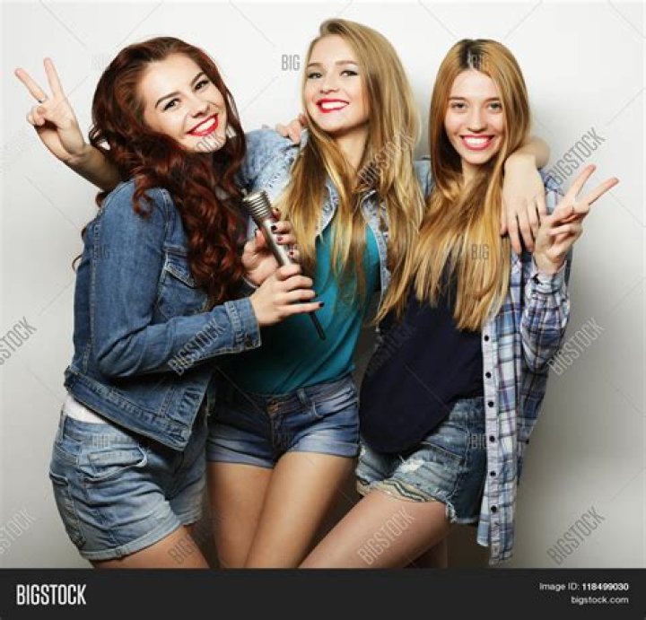 Three friends posing together for a promo photo for 100 Things to do before High School