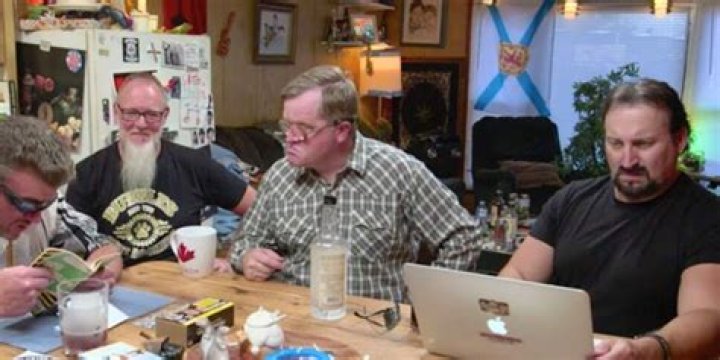 Tom Termeer sitting on a table with the cast of Trailer Park Boys