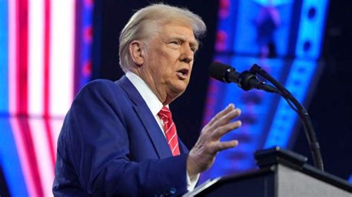 Trump speaking into a microphone