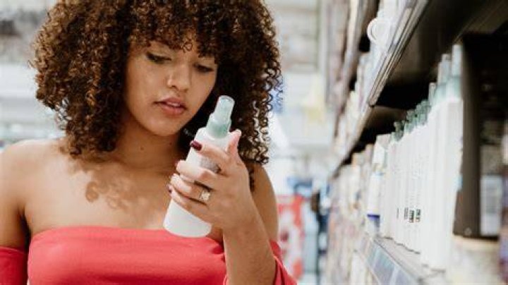 woman looking at hair product