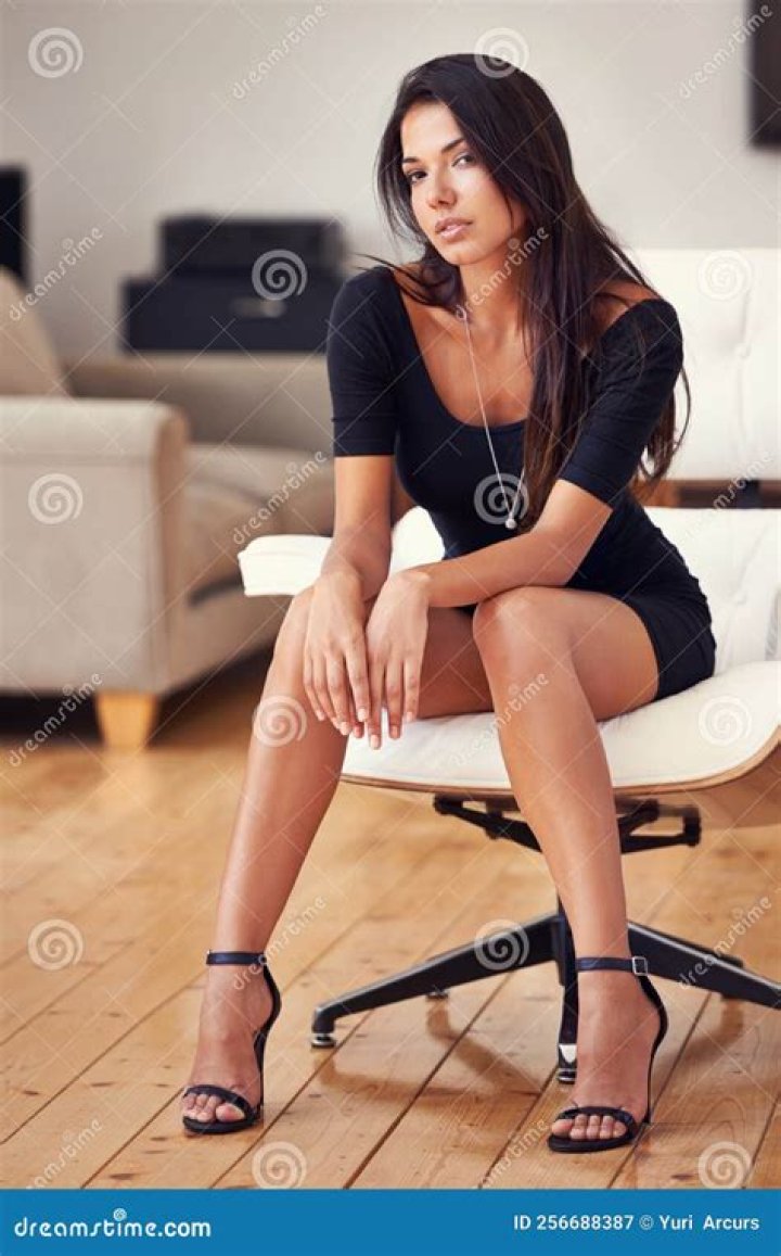 young woman sitting in chair reading